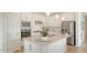 Modern kitchen featuring stainless steel appliances, white cabinets, and a quartz countertop island at 2907 61St E Ter, Ellenton, FL 34222