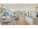 Open-concept living space with hardwood floors connecting the kitchen and dining area at 2907 61St E Ter, Ellenton, FL 34222