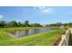 A scenic pond is surrounded by a verdant green lawn and a fence line at 2907 61St E Ter, Ellenton, FL 34222