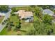 Aerial view of a charming single-story home with a screened-in lanai and lush landscaping at 3647 Country Place Blvd, Sarasota, FL 34233
