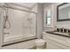 Updated bathroom featuring a shower over bath, with glass doors, and modern fixtures at 3647 Country Place Blvd, Sarasota, FL 34233