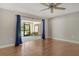 Bright bedroom featuring hardwood floors, ceiling fan, and sliding glass doors to a patio at 3647 Country Place Blvd, Sarasota, FL 34233