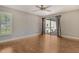 Empty bedroom featuring hardwood floors, sliding door, and great natural light at 3647 Country Place Blvd, Sarasota, FL 34233