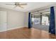 Bedroom offers hardwood floors, a ceiling fan, and sliding glass doors to a screened lanai at 3647 Country Place Blvd, Sarasota, FL 34233