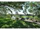 Scenic community pond with bench seating under a tree at 3647 Country Place Blvd, Sarasota, FL 34233