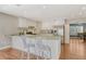 Bright open kitchen featuring white cabinets, a breakfast bar, and stainless steel appliances at 3647 Country Place Blvd, Sarasota, FL 34233