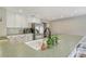 Well-lit kitchen featuring white cabinetry, stainless steel appliances, and an island with seating at 3647 Country Place Blvd, Sarasota, FL 34233