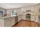 Open kitchen with white cabinets, stainless steel appliances, and a view of the backyard at 3647 Country Place Blvd, Sarasota, FL 34233