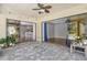 Spacious lanai with tile flooring and outdoor seating, seamlessly connecting indoor and outdoor living at 3647 Country Place Blvd, Sarasota, FL 34233