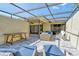 Spacious screened lanai offering a relaxing outdoor space with comfortable seating and lush greenery at 3647 Country Place Blvd, Sarasota, FL 34233