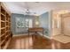 Welcoming living room with hardwood floors, built-in shelving, piano, and natural light at 3647 Country Place Blvd, Sarasota, FL 34233