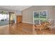 Open living space with wood-look flooring, large windows, and access to an outdoor patio at 3647 Country Place Blvd, Sarasota, FL 34233