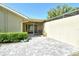 Enclosed patio offers privacy with brick pavers, a fan, and manicured shrubbery at 3647 Country Place Blvd, Sarasota, FL 34233