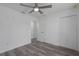 Bedroom featuring a ceiling fan, gray wood flooring, and closet space at 3712 19Th E St, Bradenton, FL 34208