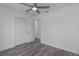 Bedroom featuring a ceiling fan, gray wood flooring, and closet space at 3712 19Th E St, Bradenton, FL 34208