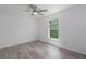 Bright bedroom features wood-look floors, a ceiling fan, and a window at 3712 19Th E St, Bradenton, FL 34208