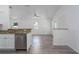 View of open-concept kitchen featuring stainless steel dishwasher and granite countertop bar at 3712 19Th E St, Bradenton, FL 34208