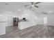 Bright, open-concept living room and kitchen with stainless steel appliances and ceiling fans at 3712 19Th E St, Bradenton, FL 34208