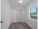 Utility room with gray wood flooring, window, and door to the backyard at 3712 19Th E St, Bradenton, FL 34208