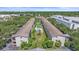 Aerial view showcasing the complex buildings, verdant landscaping and sparkling community pool at 3751 S School Ave # 19, Sarasota, FL 34239