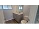 Bathroom features a single sink vanity with gray cabinets and a large mirror, plus a toilet and window at 3751 S School Ave # 19, Sarasota, FL 34239