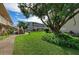 Exterior of the property surrounded by lush green grass and a large mature tree, offering a serene environment at 3751 S School Ave # 19, Sarasota, FL 34239