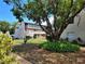 Exterior view of the building surrounded by lush landscaping, offering a tranquil living environment at 3751 S School Ave # 19, Sarasota, FL 34239
