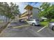 Exterior of the building featuring assigned parking spaces for residents and guests of the community at 3751 S School Ave # 19, Sarasota, FL 34239