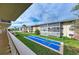 Shuffleboard court from screened in porch overlooking the green grass and buildings, offering a place to relax at 3751 S School Ave # 19, Sarasota, FL 34239