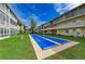 Shuffleboard court surrounded by green grass, and buildings, offering a recreational space for residents at 3751 S School Ave # 19, Sarasota, FL 34239