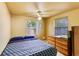 Bedroom with a large bed, two windows, a ceiling fan, and a wooden dresser at 409 Olive Ave, Nokomis, FL 34275