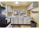 Well-lit kitchen with essential appliances, plenty of counter space, and bright natural light at 409 Olive Ave, Nokomis, FL 34275
