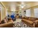 Relaxing living room featuring brown couches, a table, and a ceiling fan at 409 Olive Ave, Nokomis, FL 34275