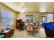 Bright and welcoming dining area with natural light, ceiling fan, and access to a screened-in porch at 409 Olive Ave, Nokomis, FL 34275