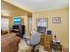 Combination room with an office area, a TV and brown couches at 409 Olive Ave, Nokomis, FL 34275