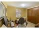 Office with a closet, a neutral-colored chair, a desk and a window with blinds at 409 Olive Ave, Nokomis, FL 34275
