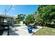 Spacious backyard featuring a patio, outdoor dining area, grill, lush lawn, and mature trees at 4616 22Nd W Ave, Bradenton, FL 34209