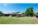 Expansive backyard with a shed, patio, and lush green lawn under a clear blue sky at 4616 22Nd W Ave, Bradenton, FL 34209