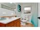 Bathroom with a wood vanity, beach decor, and large mirror over the sink at 4616 22Nd W Ave, Bradenton, FL 34209