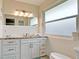 Bright bathroom featuring a granite countertop, modern fixtures, and tiled walls at 4616 22Nd W Ave, Bradenton, FL 34209