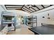 Bright, airy bedroom with two sets of gray bunk beds and a ping pong table at 4616 22Nd W Ave, Bradenton, FL 34209