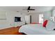 Well-lit bedroom features a TV, closet, and an ensuite bathroom with natural light at 4616 22Nd W Ave, Bradenton, FL 34209