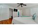 Bedroom features closet, hardwood floors, ceiling fan, and large bed with blue decorative pillow at 4616 22Nd W Ave, Bradenton, FL 34209