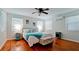 Bright bedroom features wood floors, ceiling fan, and beach-themed decor at 4616 22Nd W Ave, Bradenton, FL 34209
