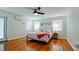 Airy bedroom with hardwood floors, a ceiling fan, and a bed with decorative pillows at 4616 22Nd W Ave, Bradenton, FL 34209