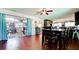 Dining area with sliding glass doors, wood floors, and a view of the modern kitchen and backyard at 4616 22Nd W Ave, Bradenton, FL 34209