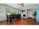Open dining room with a fireplace, wood floors, large windows, and a sleek dining table set at 4616 22Nd W Ave, Bradenton, FL 34209