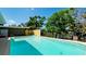 Sparkling blue pool nestled in a serene backyard with a picturesque lake view and manicured landscaping at 4616 22Nd W Ave, Bradenton, FL 34209
