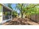 Spacious backyard featuring a storage shed, fire pit, and tropical landscaping at 4721 Garcia Ave, Sarasota, FL 34233