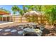 Landscaped backyard featuring a unique mosaic table and bench set, perfect for outdoor gatherings at 4721 Garcia Ave, Sarasota, FL 34233